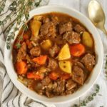 Dutch oven beef stew is healthy, easy, & is made all in one pot! Make sure to use a cast iron pot in the oven, & don't forget the red wine!