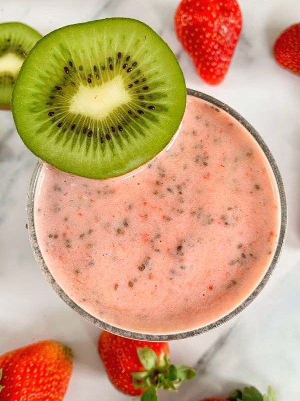 Add a strawberry banana kiwi smoothie to your day! It's easy, healthy, & made with almond milk, Greek yogurt, & high quality protein powder!