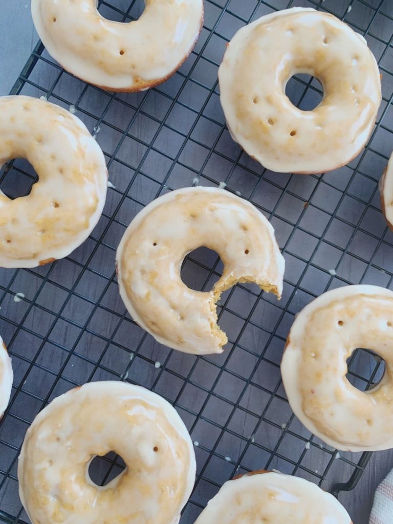 Protein donuts with maple glaze, the middle donut with a bite taken.