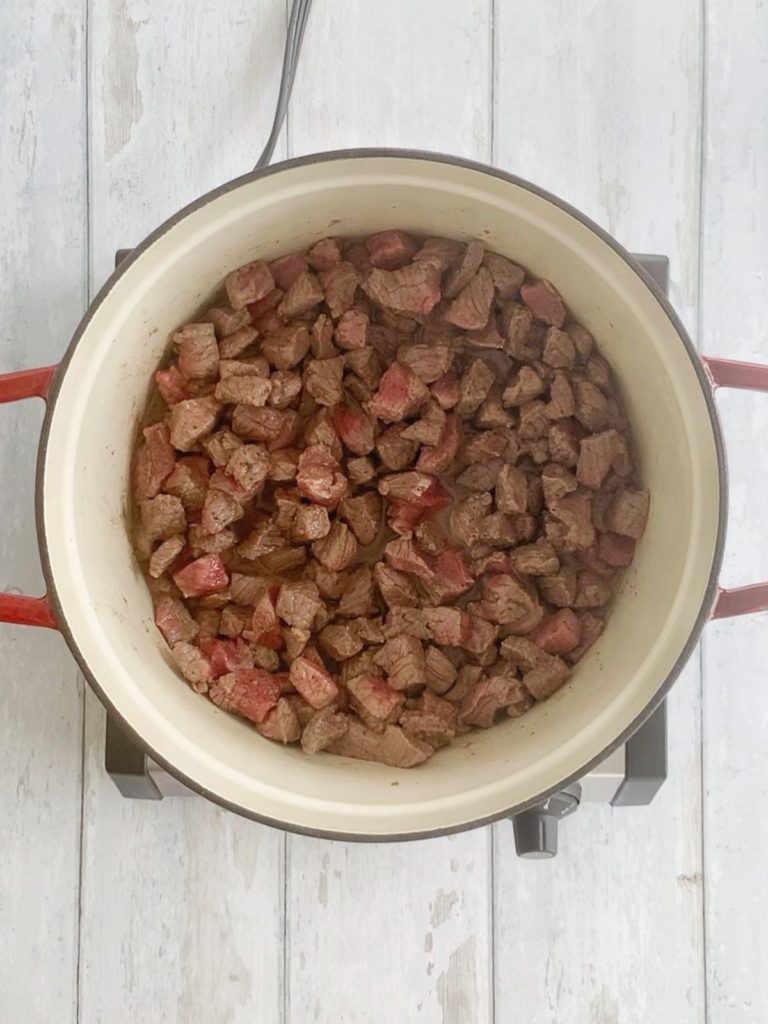 Stew meat browned inside of a cast iron dutch oven.