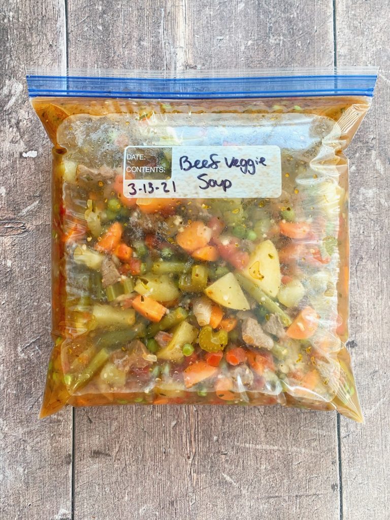 A gallon-sized zip lock bag full of instant pot beef vegetable soup