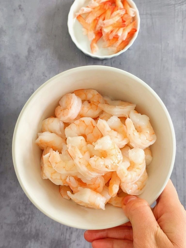 A bowl with deveined shrimp for the orange shrimp recipe.