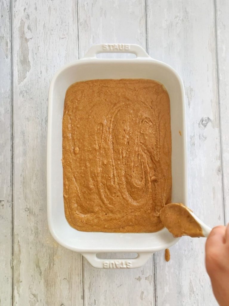 Coffee cake batter poured evenly into a baking pan.