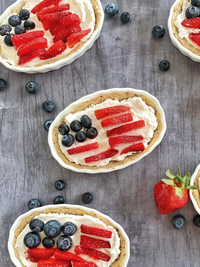 3 mini fruit tarts with blueberries and strawberries.