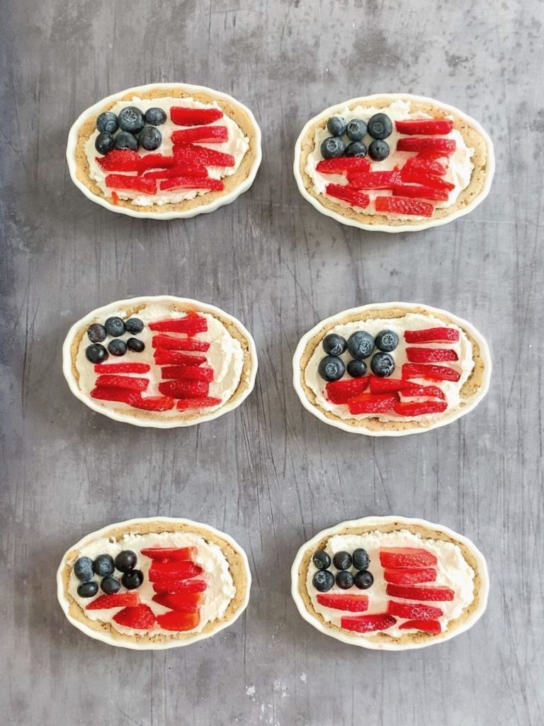 6 mini fruit tarts with berries decorated like the American flag.
