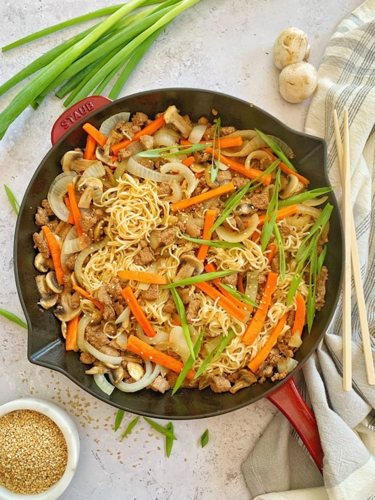 A skillet with ground turkey ramen and vegetables.