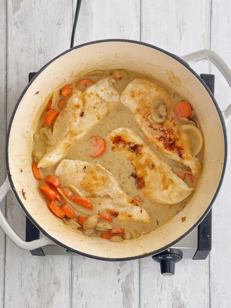 Chicken breast and vegetables together in the dutch oven.
