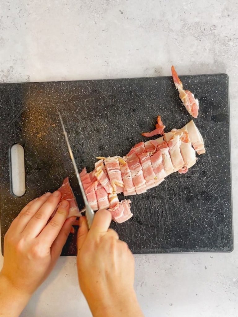 Nitrite-free bacon being cut into small pieces.