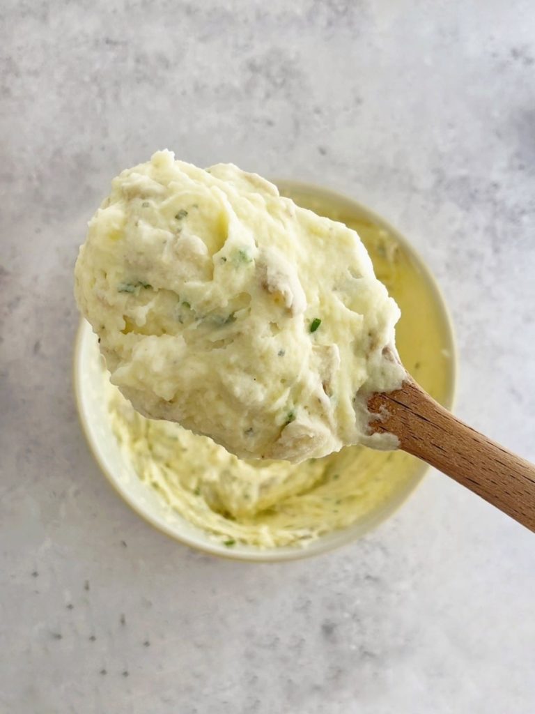Boursin garlic mashed potatoes on a serving spoon.