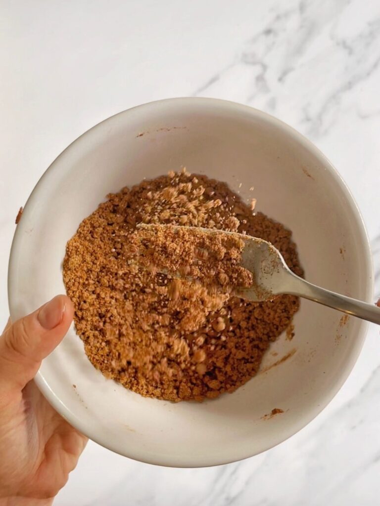 Cinnamon crumble topping in a small bowl.