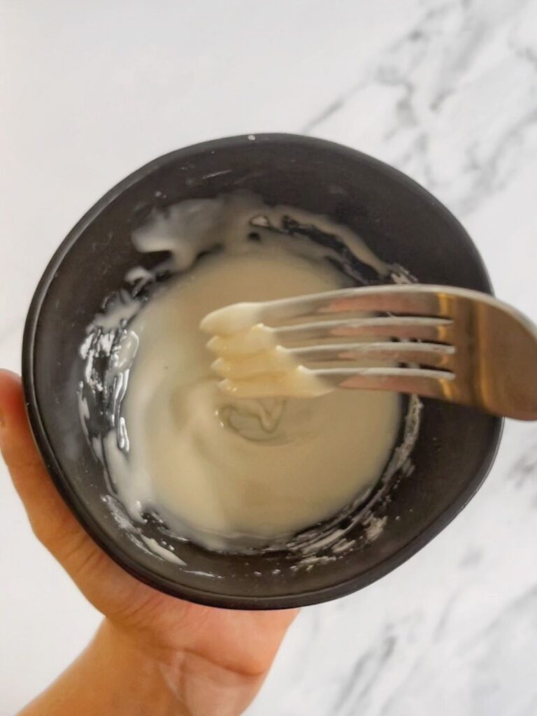 The vanilla glaze whisked in a small bowl.