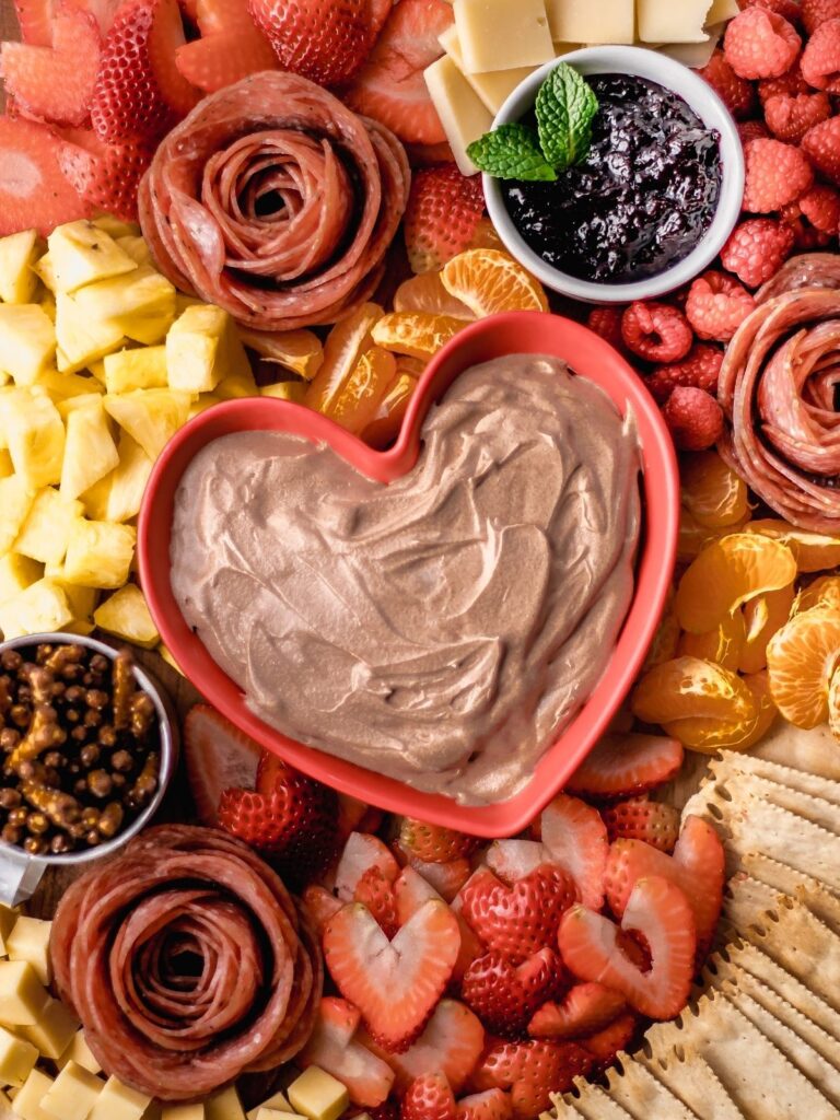 A Valentine's Day charcuterie board with chocolate fruit dip.