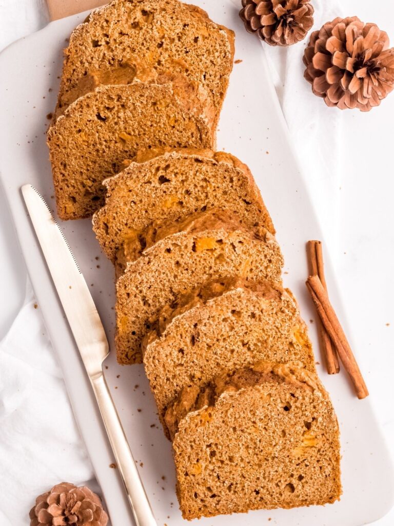 Several slices of butternut squash bread on a cutting board.