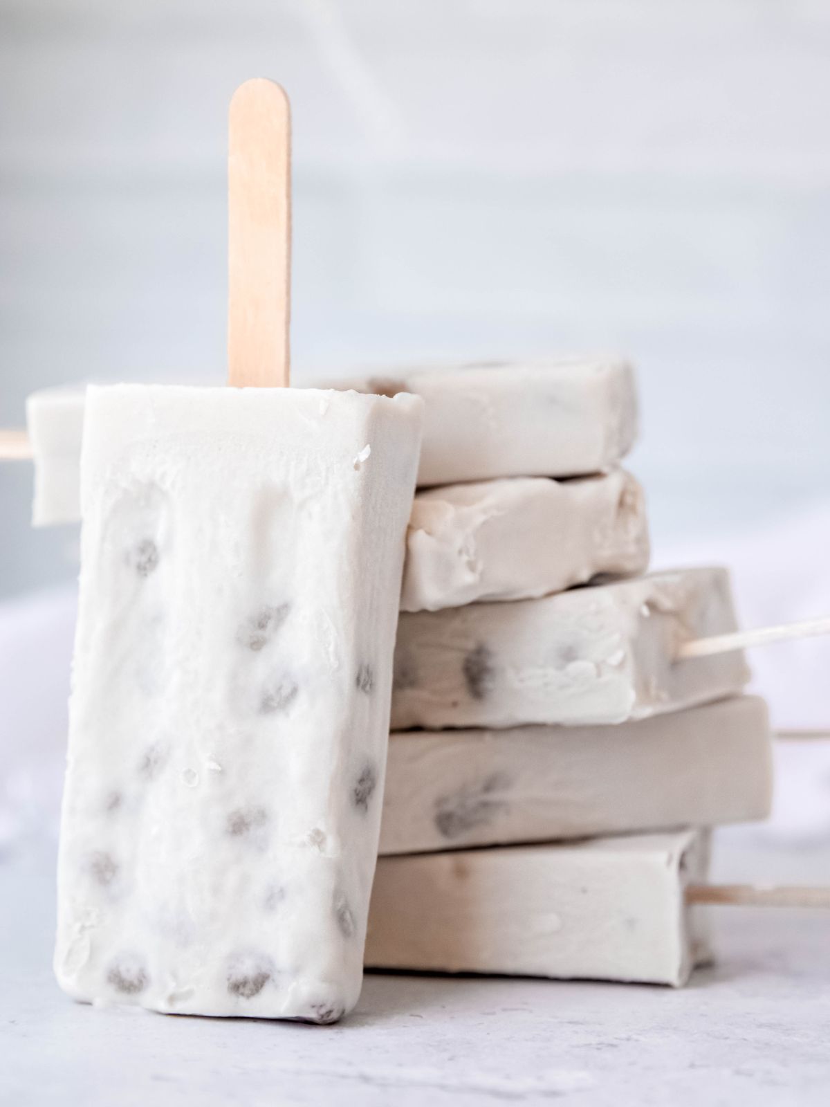 5 boba ice cream popsicles stacked up with 1 popsicle leaning against the stack.
