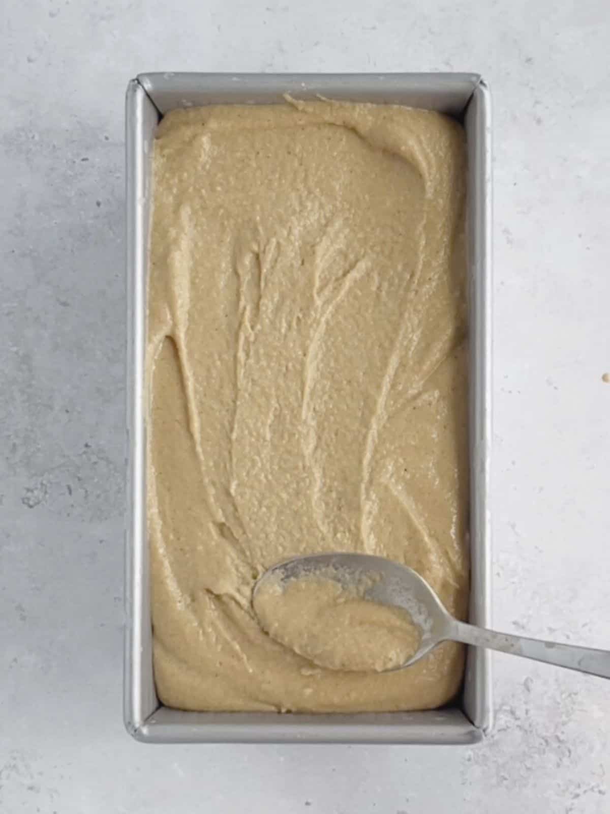 churned coffee ice cream added to a rectangular loaf tin to freeze.