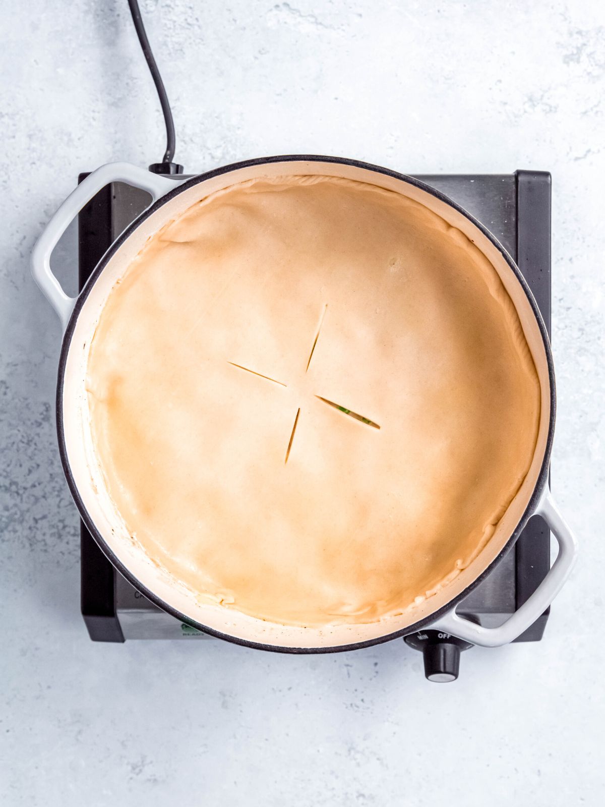 pastry crust added to the top of the pot pie gravy in the dutch oven and pressed to the sides to seal before baking.