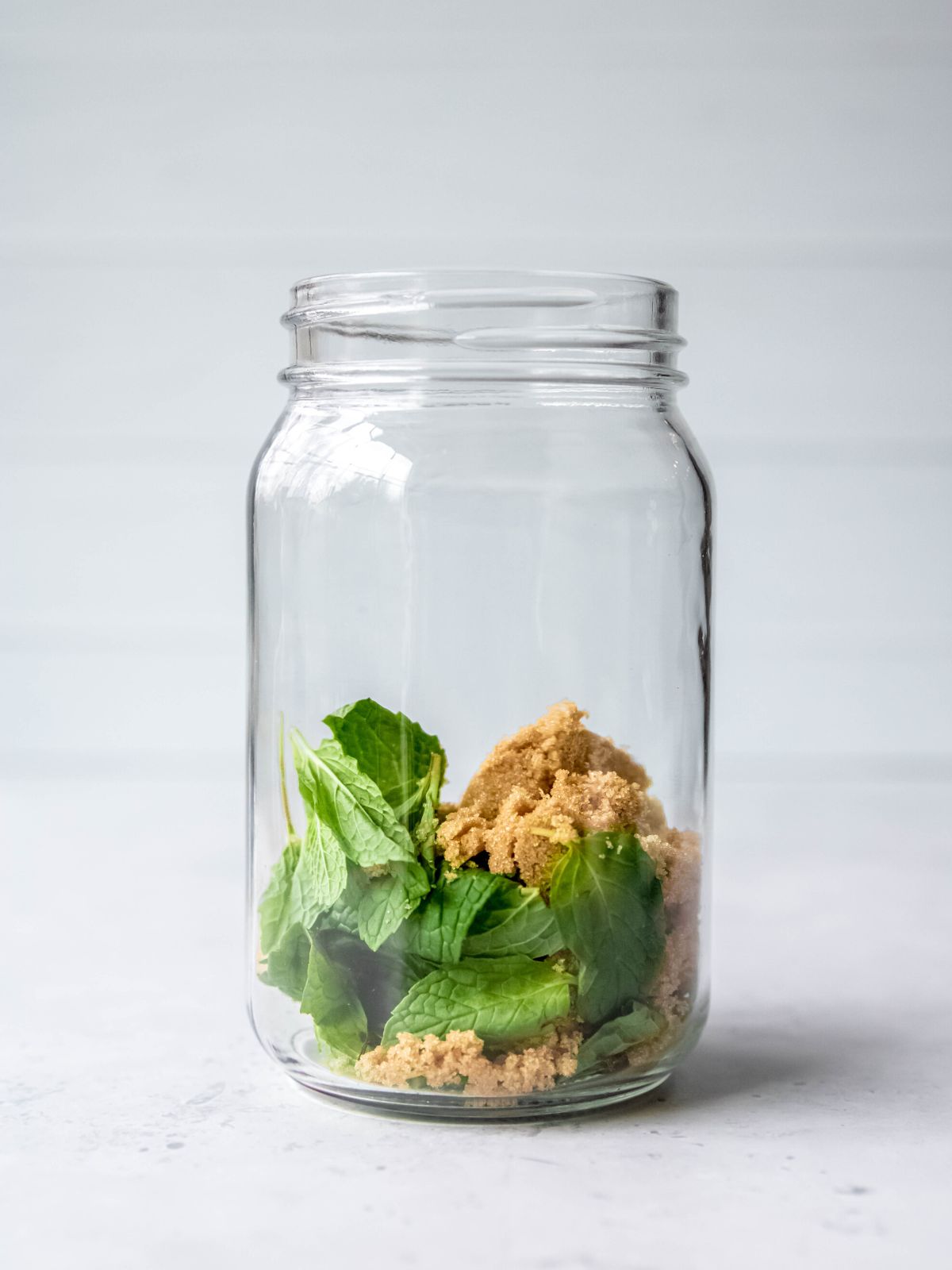 brown sugar and mint leaves in a mason jar.