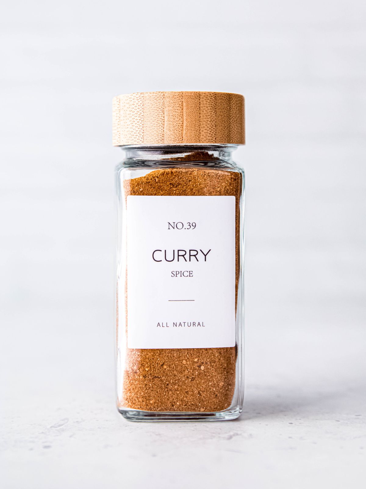 closeup shot of a cute labeled jar of homemade curry spice powder.
