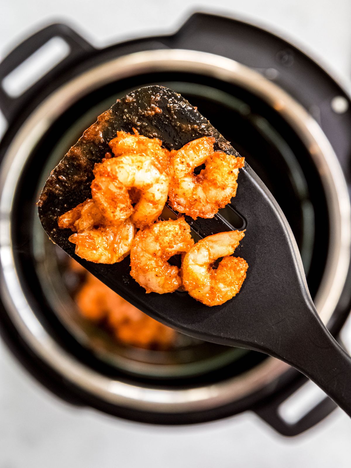 spatula showing a closeup of the airfried shrimp.