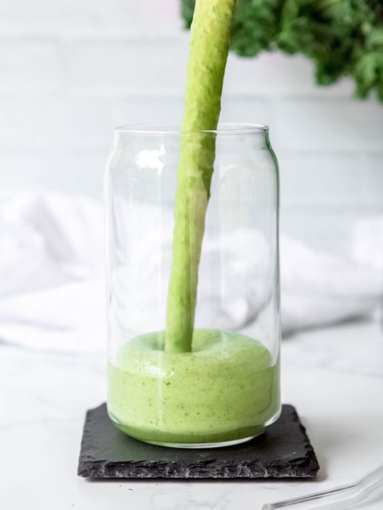 action shot of the healthy low-carb green smoothie being poured into a glass. 