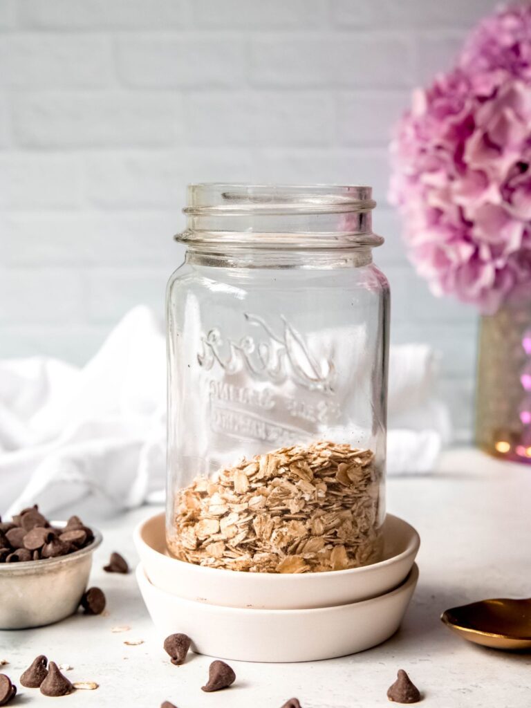 rolled oats in the bottom of a mason jar.