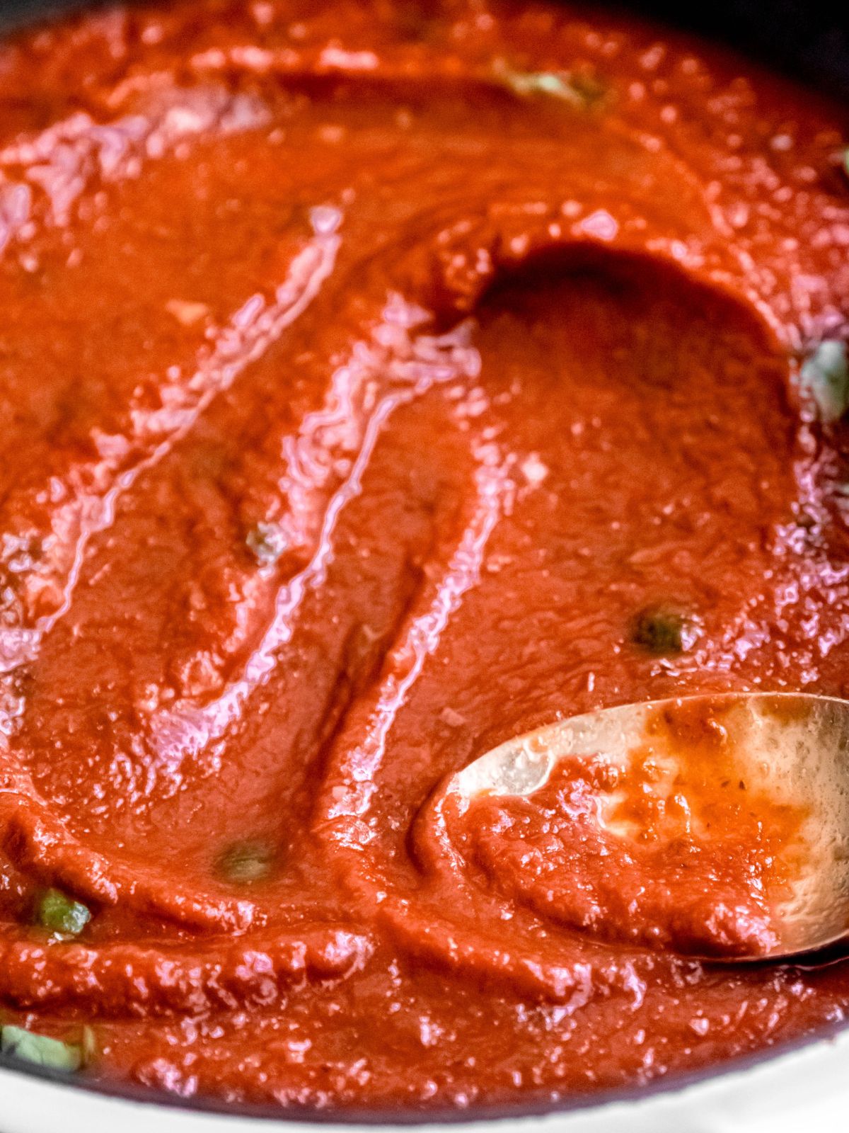 45 degree angle closeup shot of thick homemade pizza marinara in a pan.