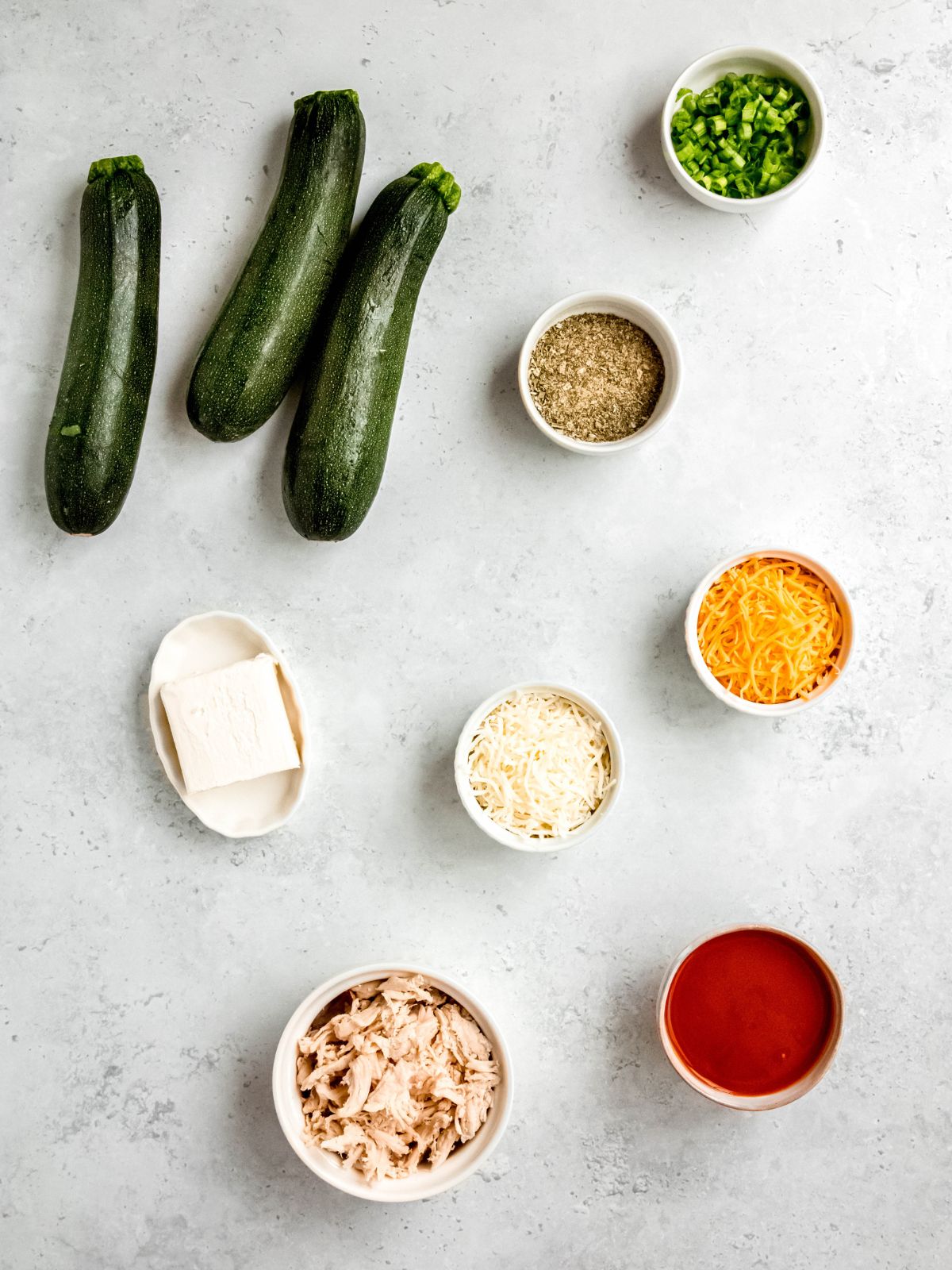 All of the ingredients for buffalo chicken zucchini boats.