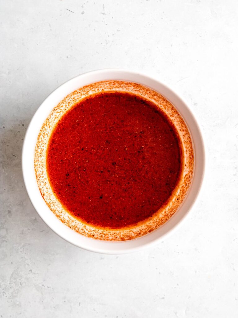bang bang chicken marinade after whisking in a white bowl.