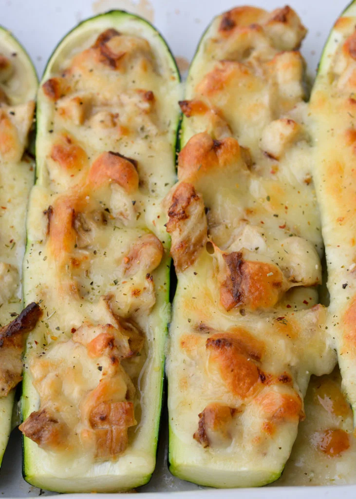 A close-up shot of chicken alfredo zucchini boats.