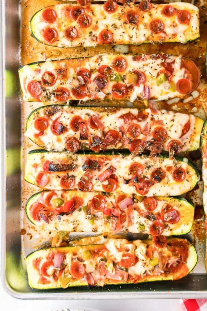 An overhead shot of a pan of pizza zucchini boats.