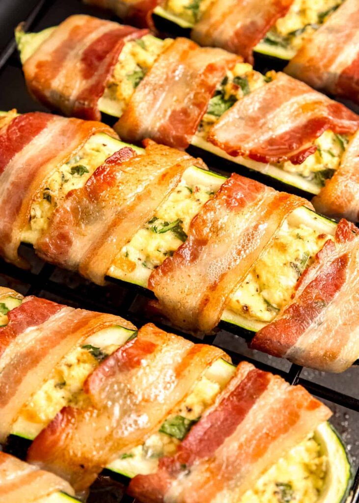 An angled shot of bacon wrapped zucchini boats.