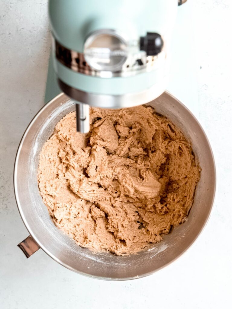 completed apple cider cookie dough in the bowl of a stand mixer.
