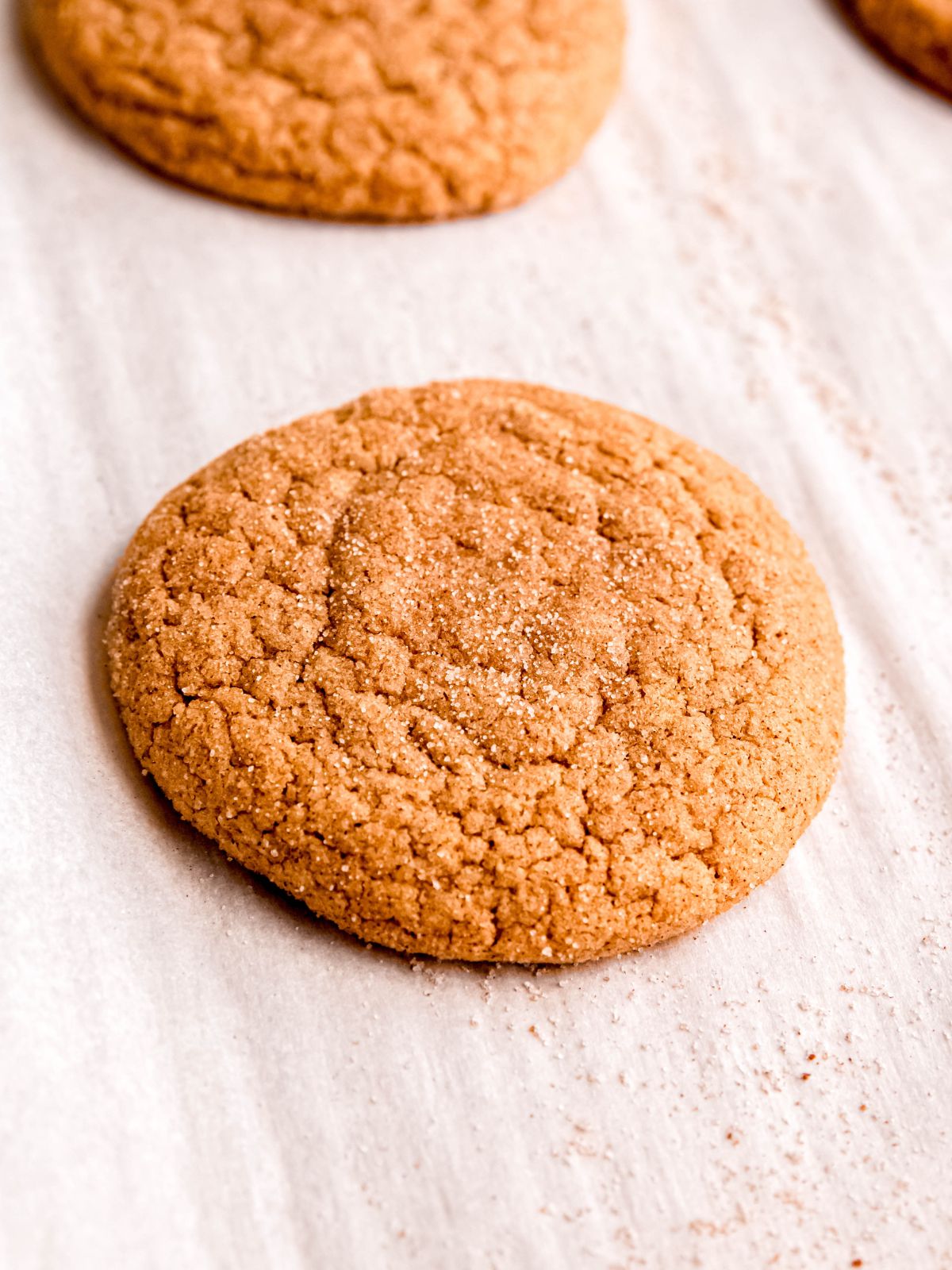baked apple cider cookie on the parchment after baking.