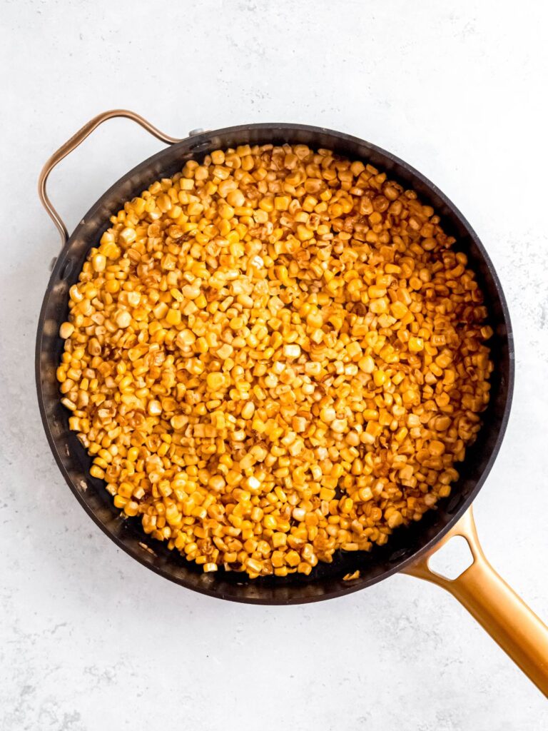 corn kernels that have been roasted till golden brown in a skillet.