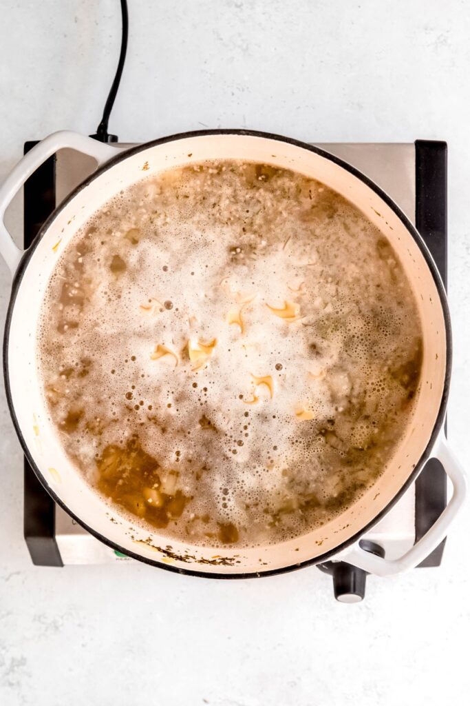 the broth is simmering and cooking the egg noodles that were added.