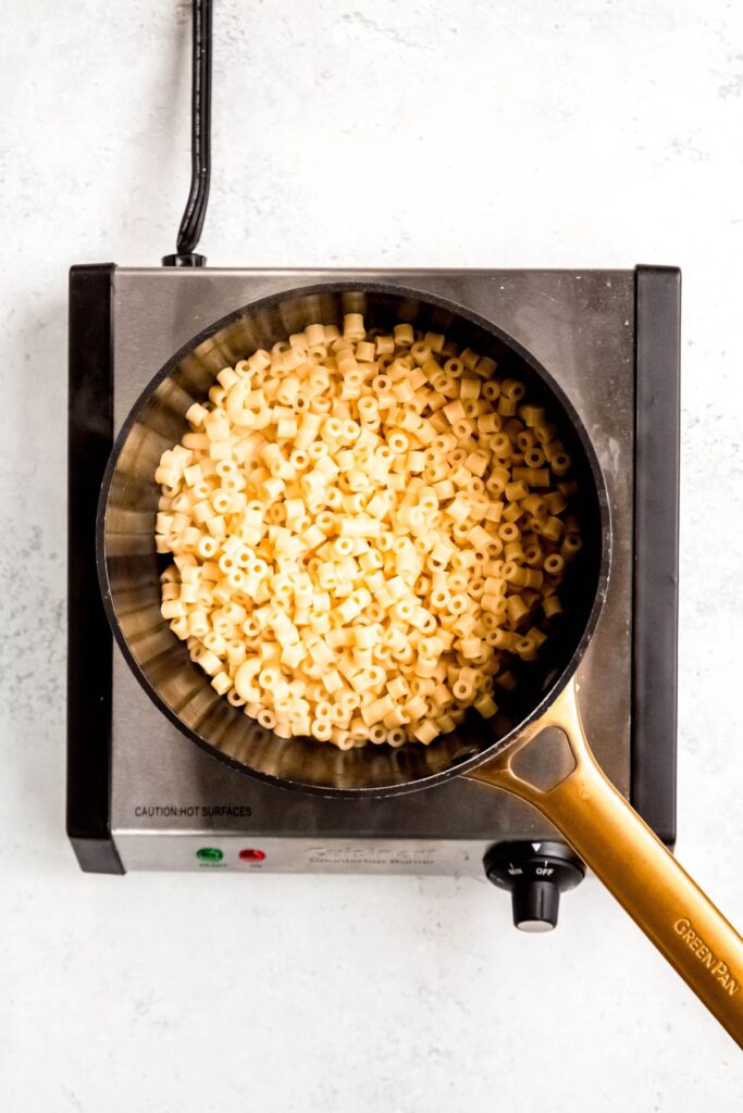 Cooked ditalini pasta in a large saucepan.