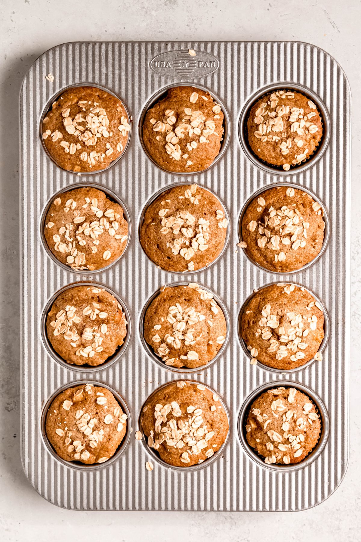 A baking tray of baked Apple cinnamon protein muffins.