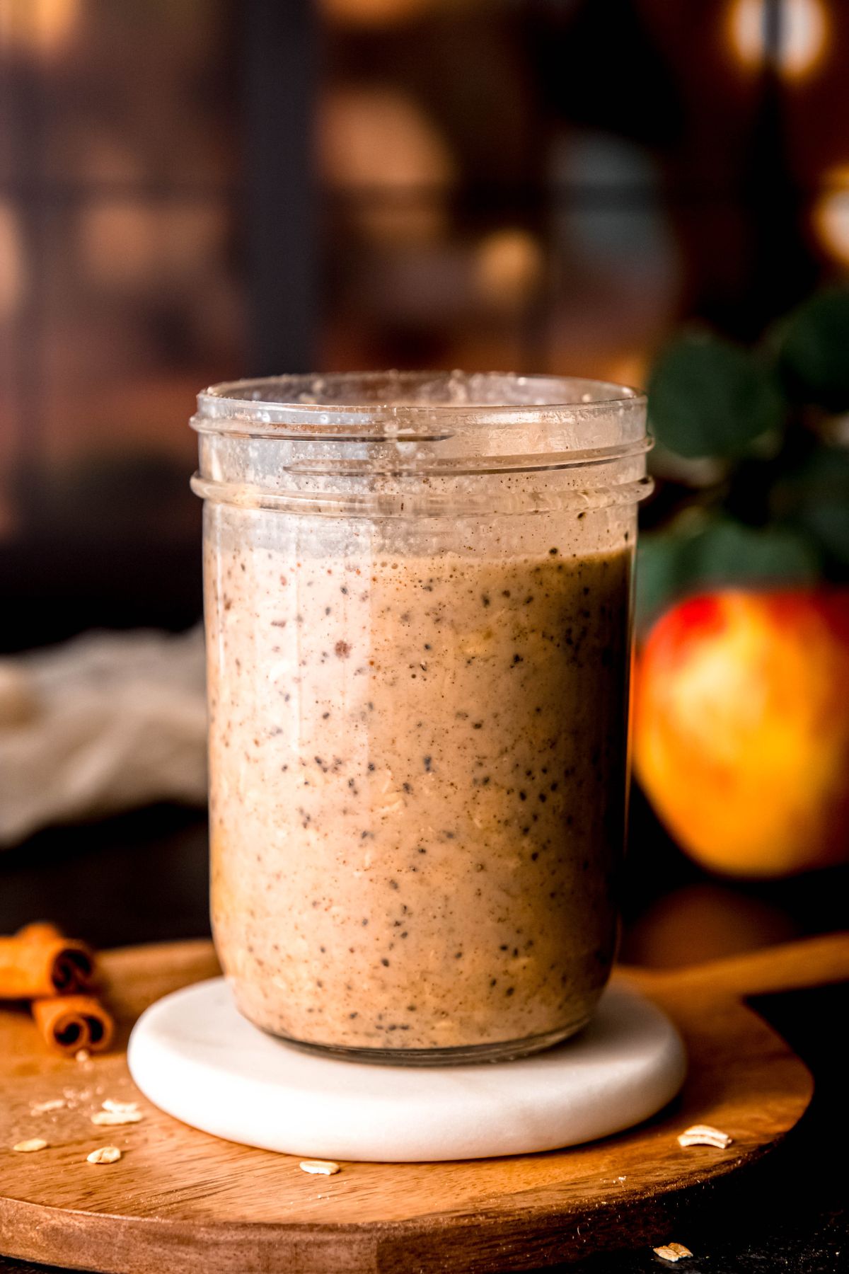 jar of cinnamon apple overnight protein oats after stirring together and refrigerating for 6 hours until the chia seeds have expanded and the oats have rehydrated.