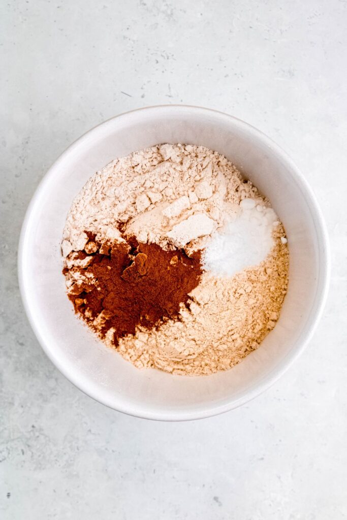 dry ingredients for making banana muffins with protein powder in a mixing bowl.