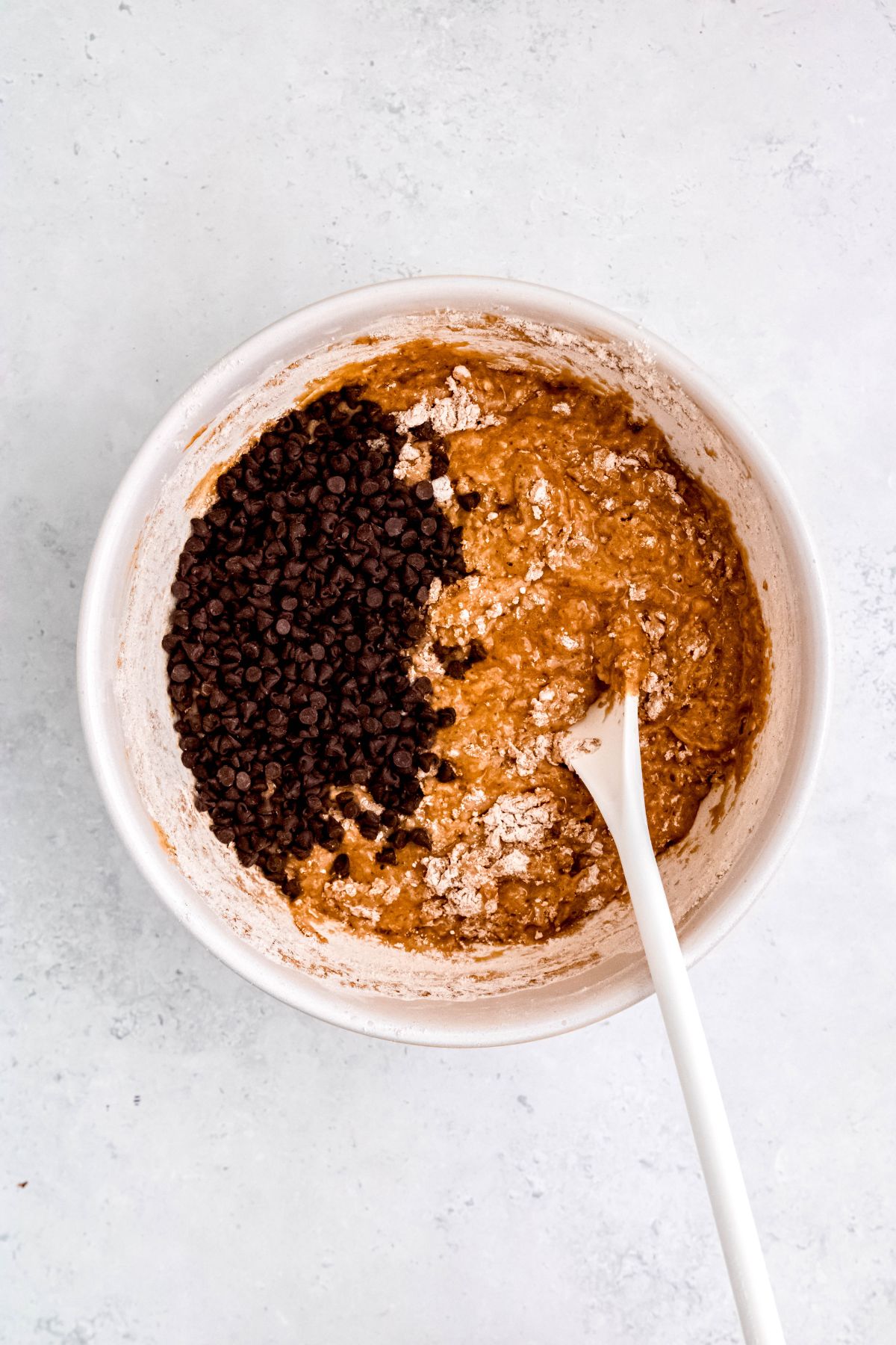 chocolate chips added to the banana protein muffin batter while there are still a few streaks of dry ingredients.