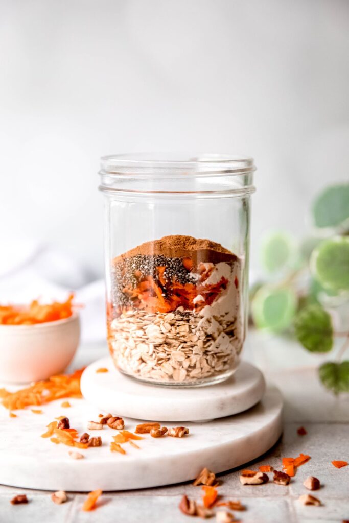 shredded carrots, chia seeds, sweetener, and spices added on top of the rolled oats.