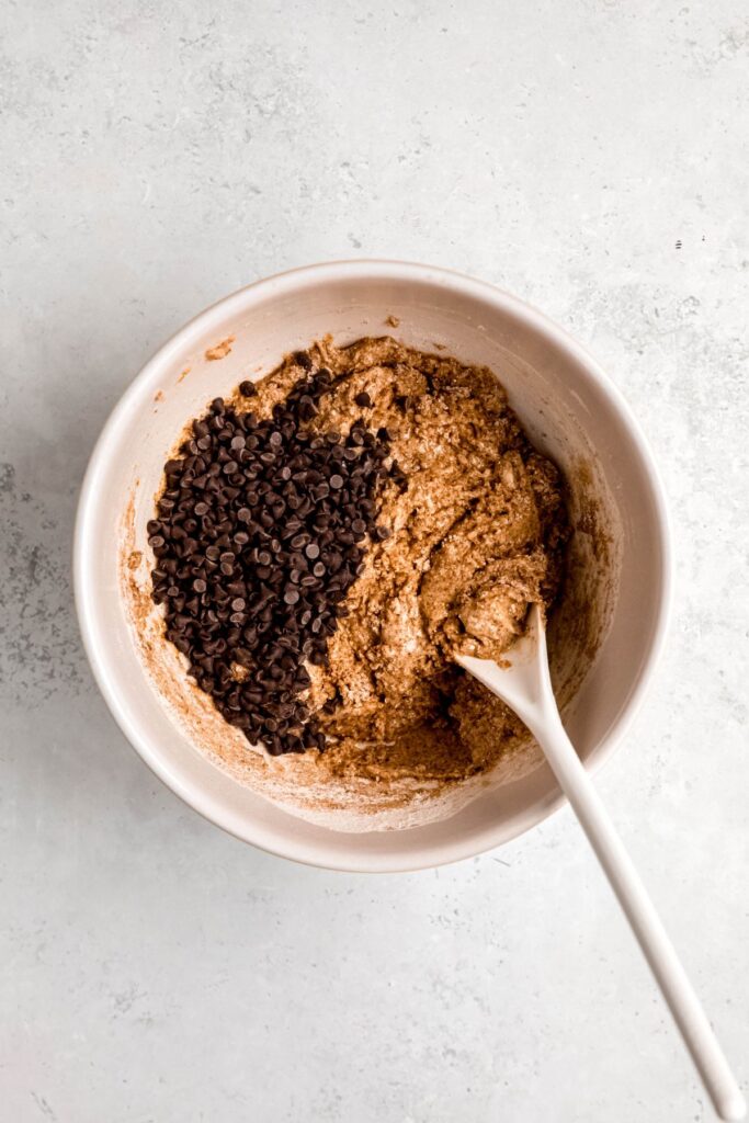 mini chocolate chips added to the bowl on top of the protein muffin batter.