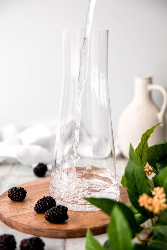 clear pitcher being filled with water.