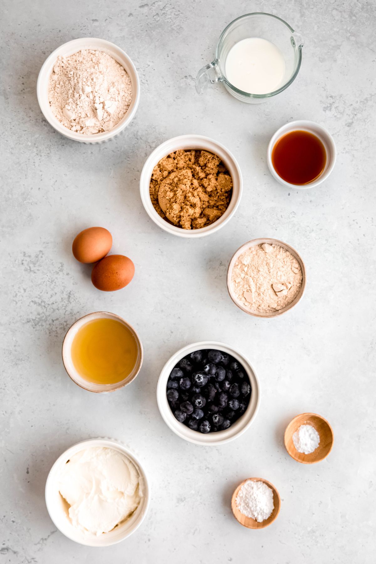 All the ingredients needed to make blueberry protein muffins.