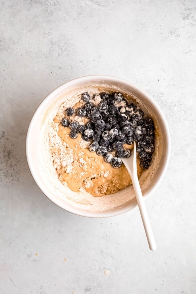 A mixing bowl with the protein muffin batter and blueberries.