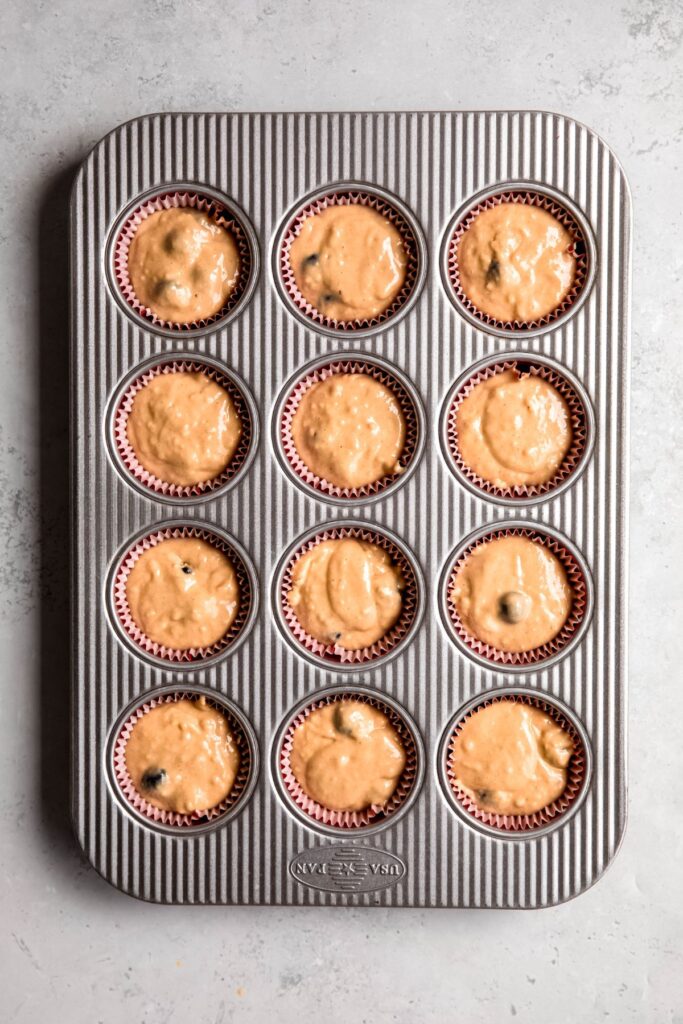 A muffin pan filled with the protein muffin batter before baking.