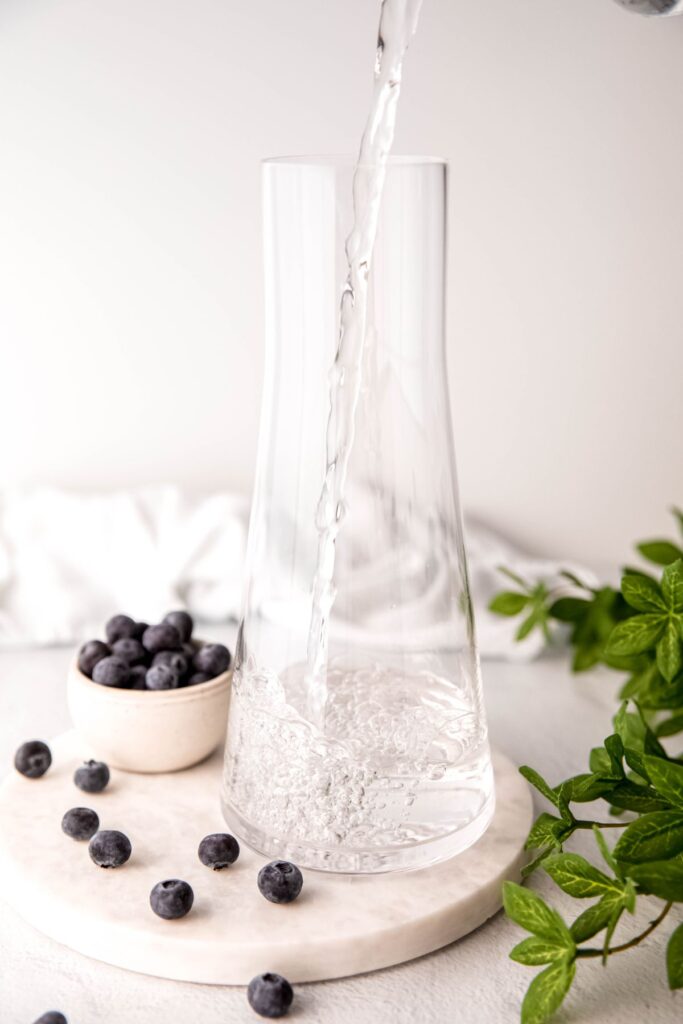 action shot of water being poured into a pitcher.