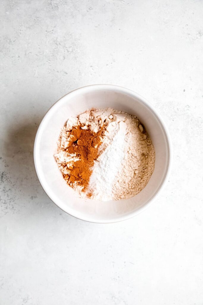 dry ingredients for healthy muffin batter in a mixing bowl before whisking.