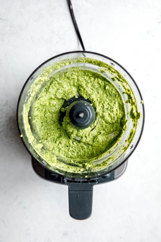 green goddess salad dressing in a food processor after blitzing.