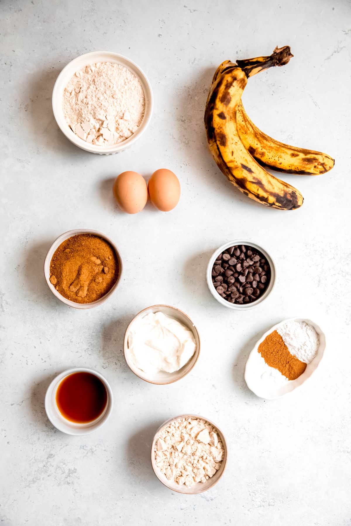 ingredients for making high protein banana bread recipe measured out on a white table.
